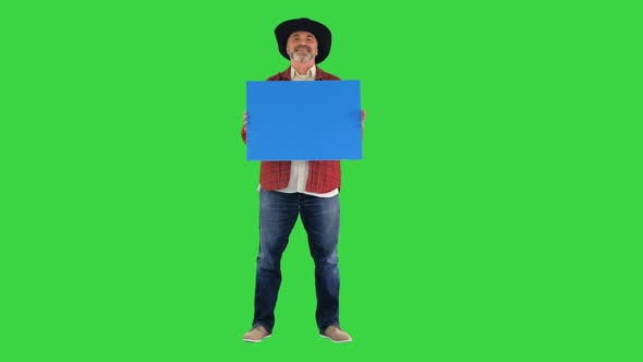 Senior Farmer in a Hat Holding Blank Placard on a Green Screen, Chroma Key