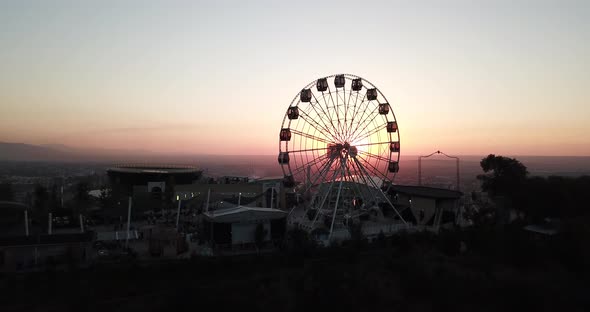Ferris Wheel on the Green Hill Kok Tobe at Sunset