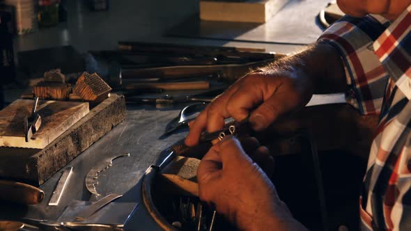 Goldsmith working in workshop