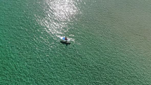 A Young Woman on a Paddleboard is Exercising in the Morning