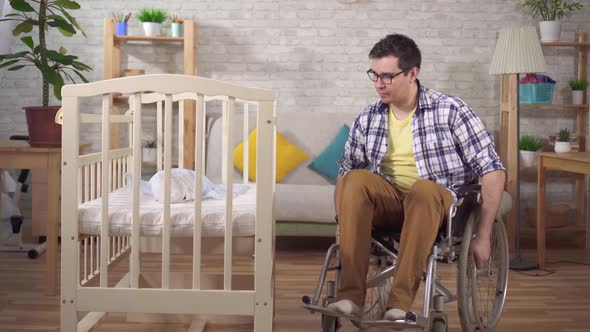 Disabled Man in a Wheelchair a Young Father in a Children's Bedroom