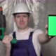 Builder in Blue Overalls and White Hard Hat Hold Mobile Phone Green Screen - VideoHive Item for Sale