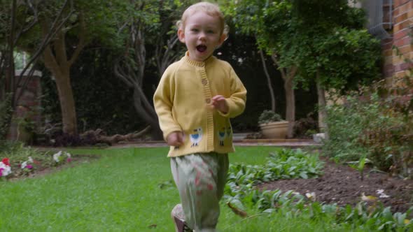 Caucasian baby running in the garden