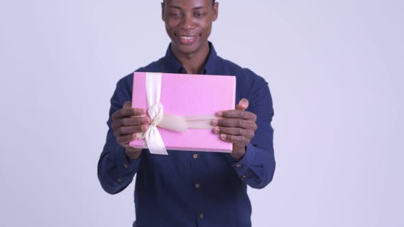 Young Happy African Businessman Giving Gift Box