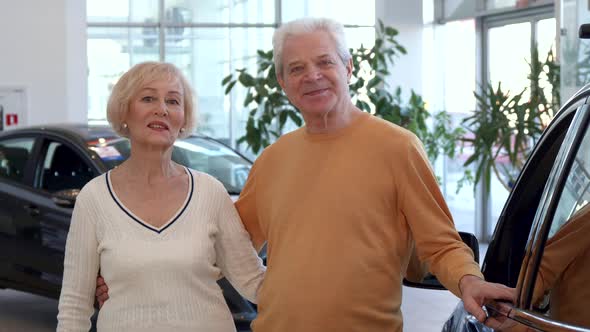 Senior Couple Buys the Car at the Dealership