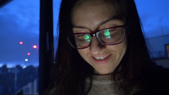 Young woman using smartphone at home in the evening