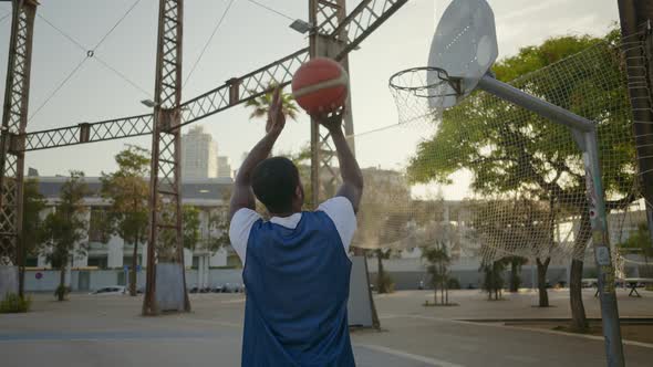 Cinematic footage of a street basketball game outdoor.