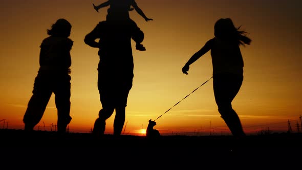 Family with Dog Run at Sunset