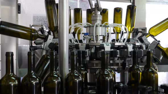 Wine bottles are sanitized in industrial machines at the wine bottling factory