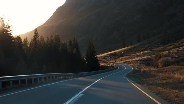 Motion On Serpentine Road In Mountains At Sunset View From Driving Car Vehicle