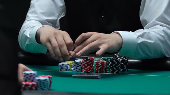 Croupier Shuffling Cards to Poker Players, Casino Chips on Table, Gambling