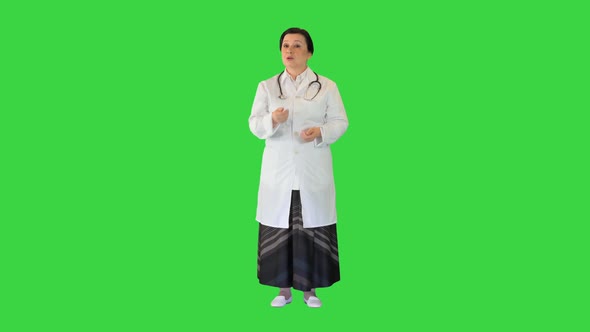 Mature Female Doctor Talking on Camera on a Green Screen Chroma Key