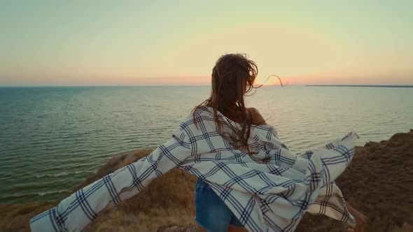 Back View Brunette Blowing Hair Woman Walking By Hill Top with the Panoramic View at Sunset