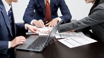 A business person making a comment at a meeting