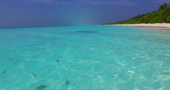 Natural birds eye abstract shot of a white paradise beach and aqua blue water background in vibrant 