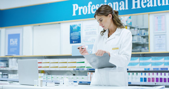 Pharmacist, laptop and checklist for pills, inventory and medicine as chemist, drugstore and employ