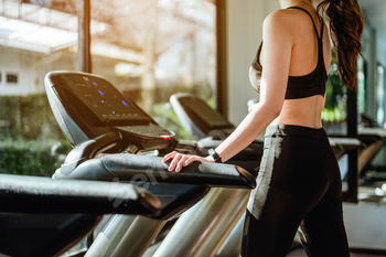 Fitness asian women running on track treadmill in the morning at  fitness gym, exercise fitness.