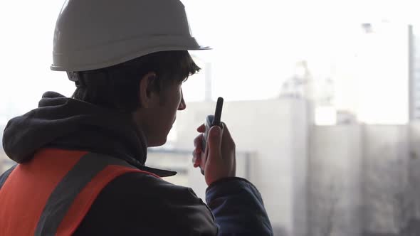 The civil engineer manages the construction process and gives the command by radio walkie-talkie.