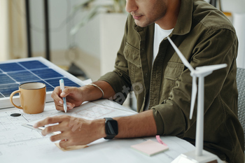 Engineer Working Over Blueprint Of New Ecology System