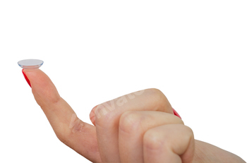 Female finger with contact lens isolated on white