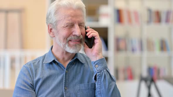 Cheerful Old Man Talking on Smartphone