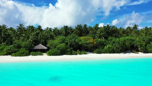 Natural fly over travel shot of a sandy white paradise beach and aqua blue ocean background in vibra