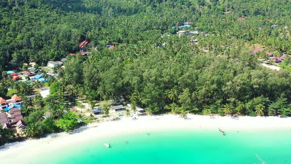 Wide above clean view of a white sandy paradise beach and blue ocean background in best quality 4K