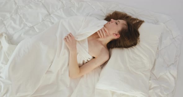 Young Woman Tosses and Turn in Her Sleep