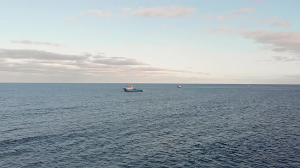 Drone flies toward a trawler fishing boat in the Atlantic Ocean, Portugal