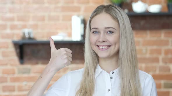 Thumbs Up by Young Woman