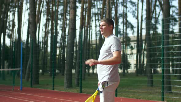 Tennis Player Preparing To Serve a Ball on Court