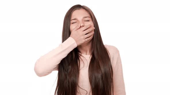 Close Up Portrait of Caucasian Female Teen Being Sleepy Yawning Covering Open Mouth and Her Eyes