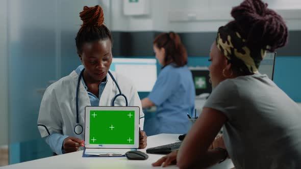 Doctor and Patient Looking at Green Screen on Tablet