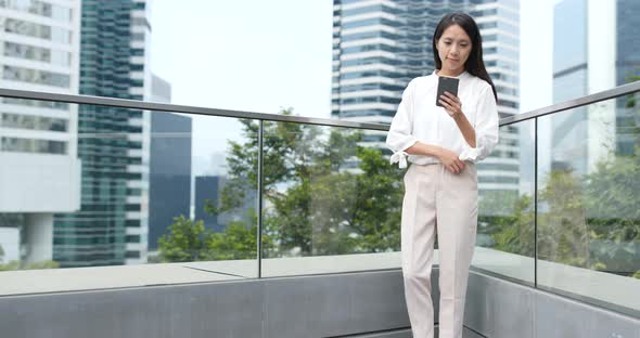 Young Woman use of mobile phone in city