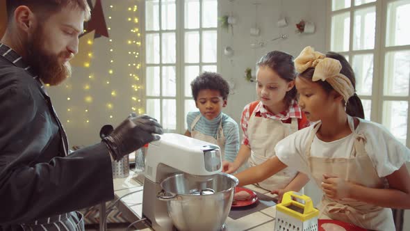 Children and Chef Using Mixer and Talking on Cooking Masterclass