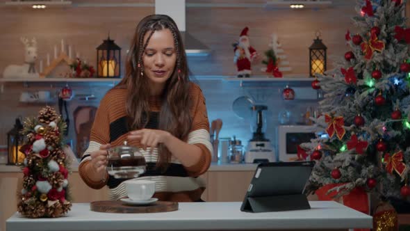 Woman Pouring Coffee While Chatting on Video Call