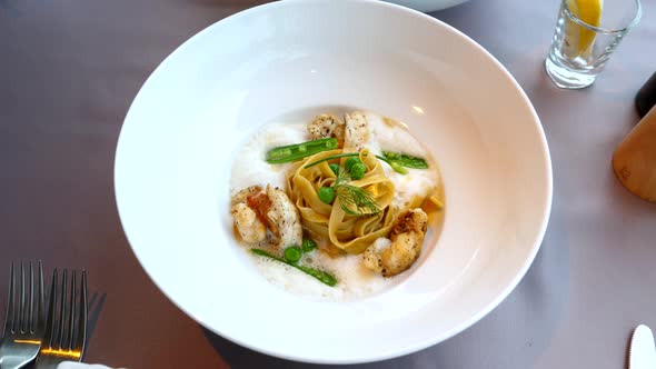 Fresh Pasta Carbonara with Seafood and Imitation of Sea Foam with Green Peas