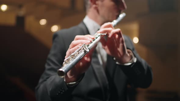 Professional Flutist is Playing Flute in Opera House or Philharmonic Hall Portrait of Musician