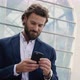 Handsome Businessman browsing his Smartphone near modern Office Building. - VideoHive Item for Sale