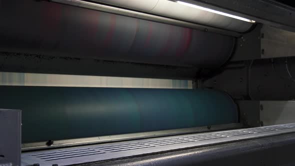Red and blue ink rolls in printing factory at high speed