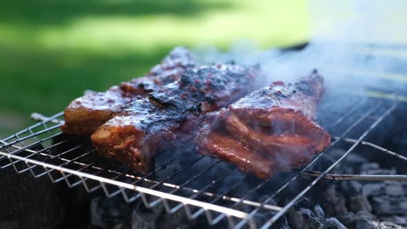 Delicious Beef or Pork Ribs Frying on a Charcoal Grill