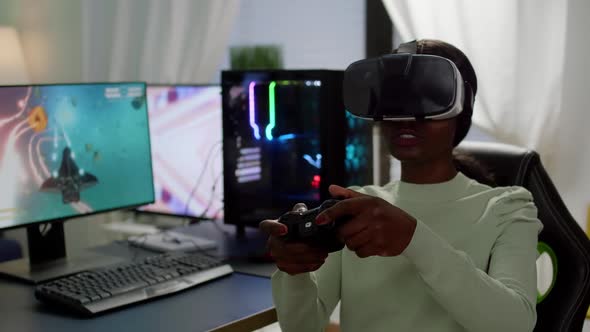 Focused African Cyber Player Wearing Virtual Reality Headset During Game