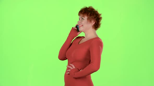 Woman Is Talking on the Phone and Smiling. Green Screen