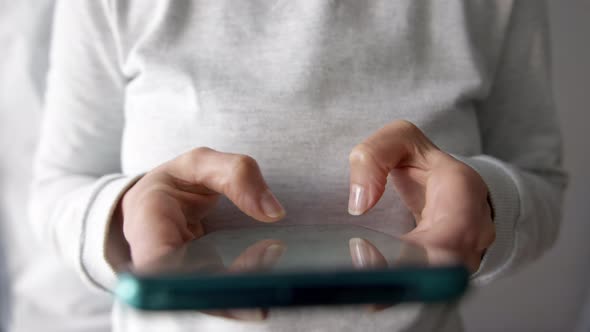 Woman writes a message on a social network using a smartphone.