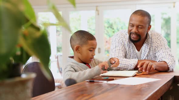 Father helping his son with his homework 