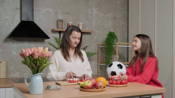 Mother Talks to Her Daughter While She Prepares the Vegetable Salad