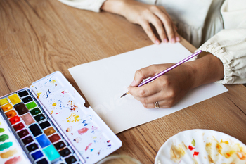 Artist Painting on White Canvas with Watercolors