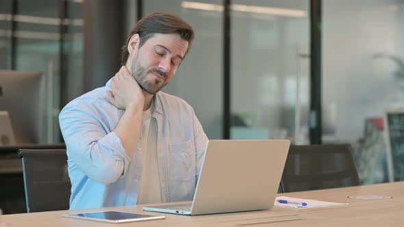 Man with Laptop Having Neck Pain