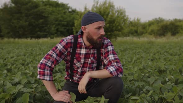 Tired Farmed Put on His Black Hat on a Field