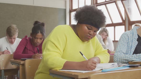 Students writing in high school class